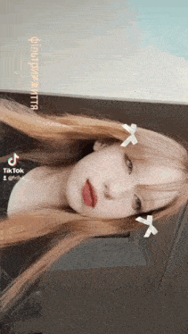 a girl with a bow in her hair has tiktok written on the bottom