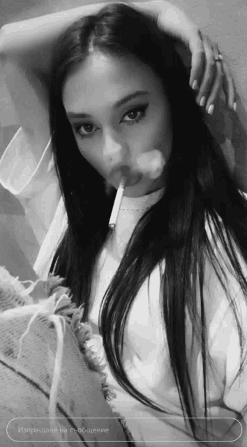 a woman with long hair is smoking a cigarette