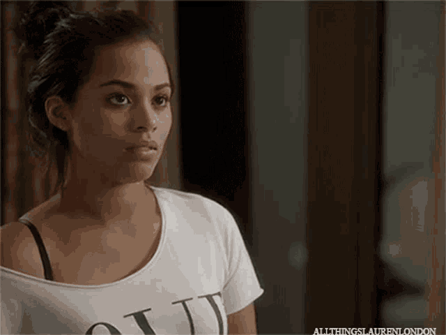 a woman wearing a white t-shirt that says " all things lauren london "
