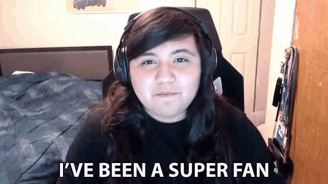 a man wearing headphones says " i 've been a super fan "