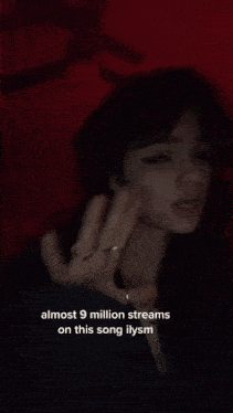 a blurred image of a person 's hand with the words " almost 9 million streams on this song ilysm "
