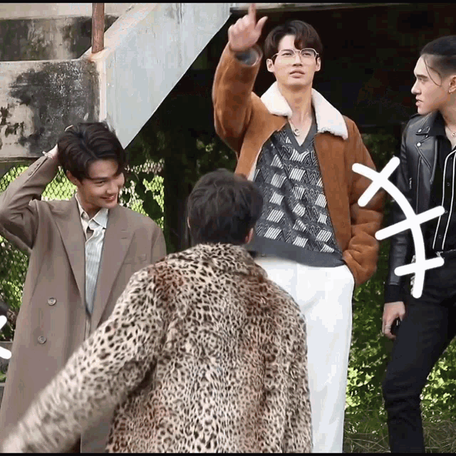 a man in a leopard print coat is standing next to another man