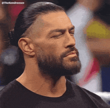 a man with a beard is wearing a black shirt with the name thekamdreesen on it