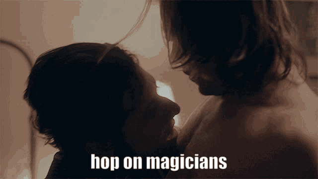 a man kissing another man with the words hop on magicians above them