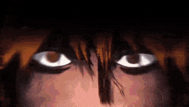 a close up of a person 's eyes with a dark background