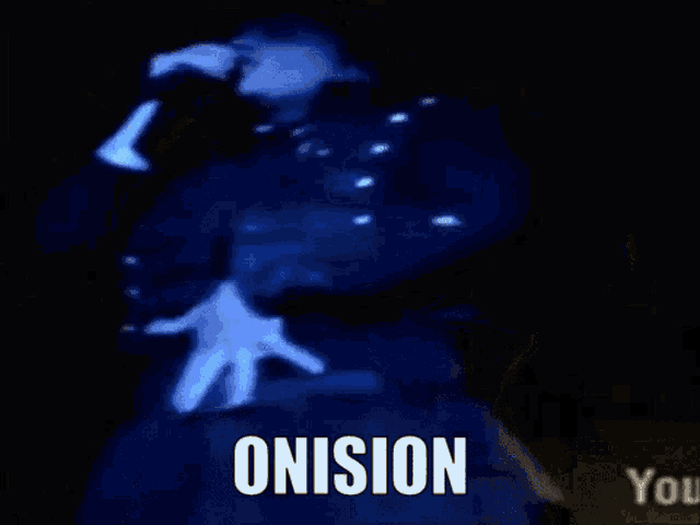 a man in a blue jacket is singing into a microphone with the word onision written on the bottom