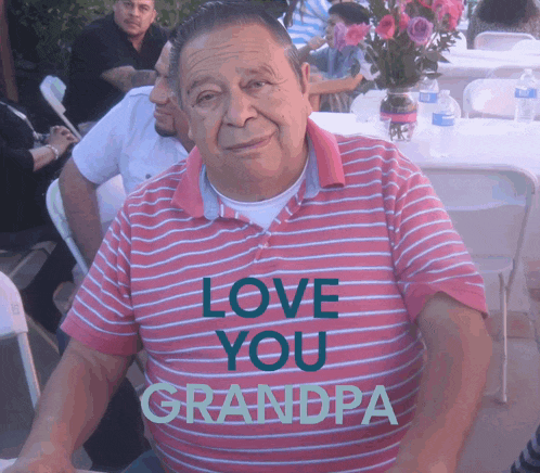 an older man wearing a pink shirt that says love you grandpa