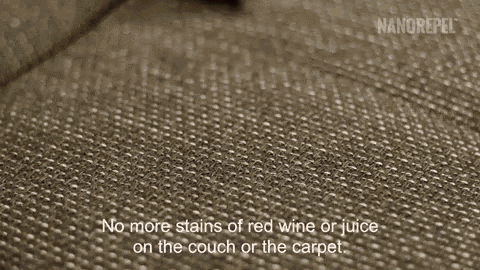 a close up of a couch with a stain of red wine or juice on it .