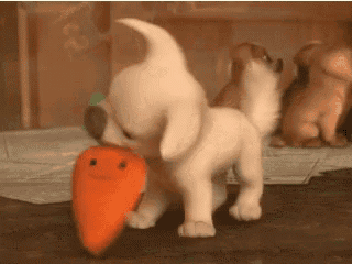 a stuffed animal dog is eating a carrot with a smiling face on it .