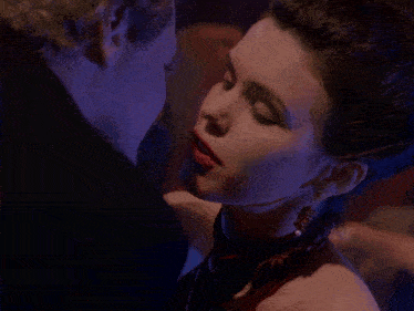 a man and a woman are kissing in the dark