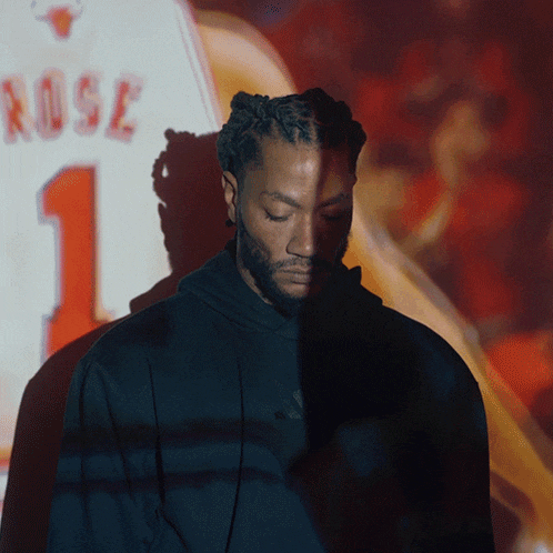 a man is standing in front of a screen that says rose