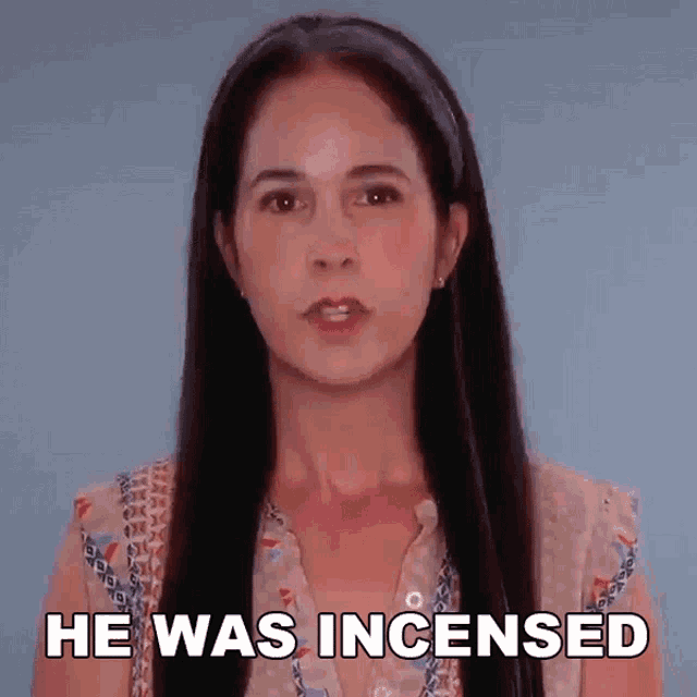 a woman with long hair says he was incensed in front of a blue background