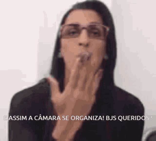 a woman blowing a kiss with the words " assim a camara se organiza "