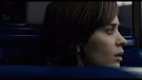 a woman is looking out of a window on a bus .