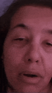 a close up of a woman 's face with her mouth open .