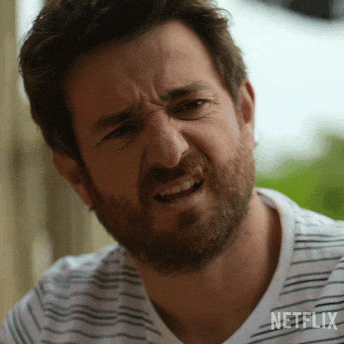 a man with a beard is wearing a striped shirt with netflix written on it
