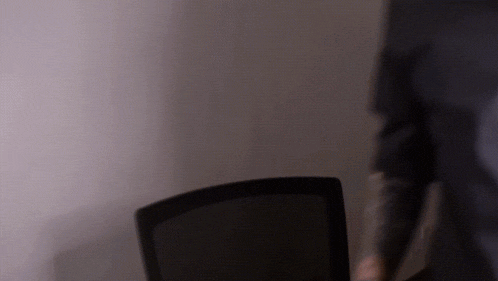 a blurry photo of a person standing in front of a chair
