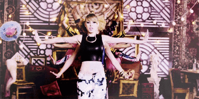 a woman in a crop top and floral skirt is dancing