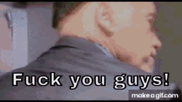 a man in a suit is standing in front of a wall and says `` fuck you guys '' .