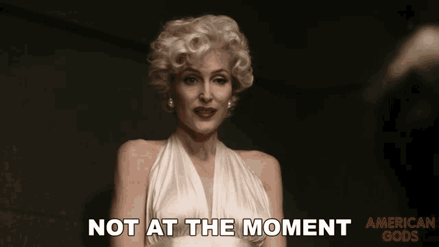 a woman in a white dress with the words not at the moment