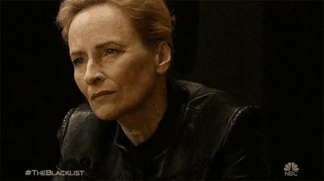 a close up of a woman 's face with the blacklist written on the bottom
