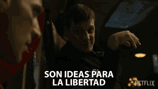 a man in a suit says son ideas para la libertad in front of another man