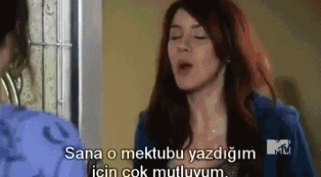 a woman in a blue jacket says sana o mektubu yazdim