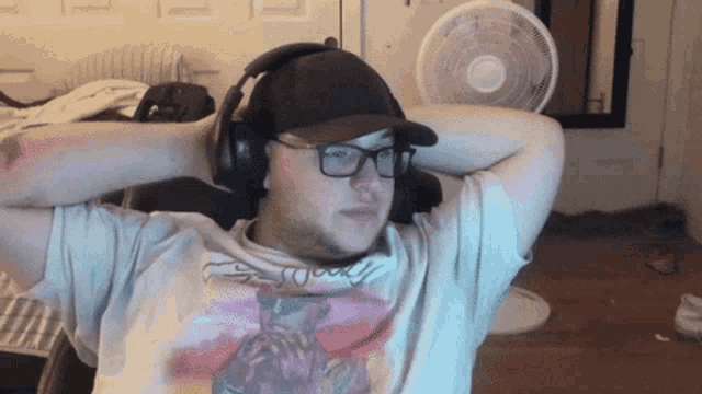 a man wearing headphones and a t-shirt that says ' goody ' on it