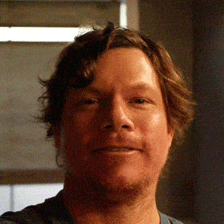 a close up of a man 's face with his eyes closed