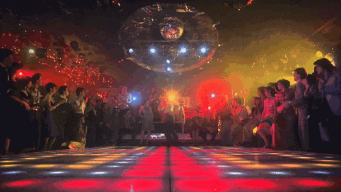 a man is dancing on a dance floor in front of a crowd