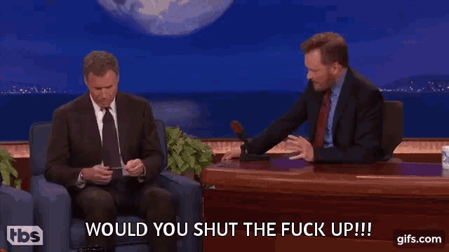 two men are sitting at a table and one of them says " would you shut the fuck up !!! "