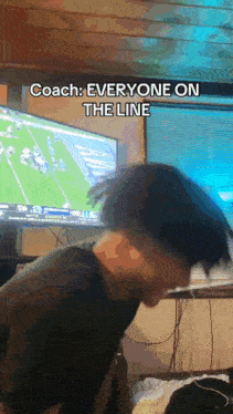 a man watching a football game with the caption coach everyone on the line on the bottom