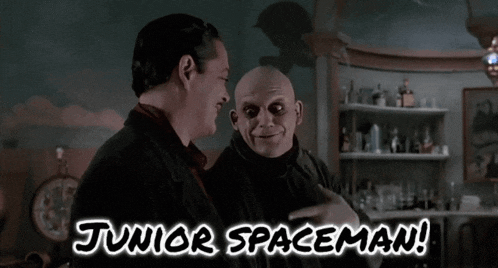 two bald men are standing next to each other with the words junior spaceman below them