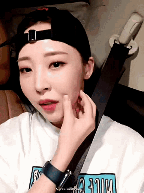 a woman wearing a baseball cap and a shirt that says mile