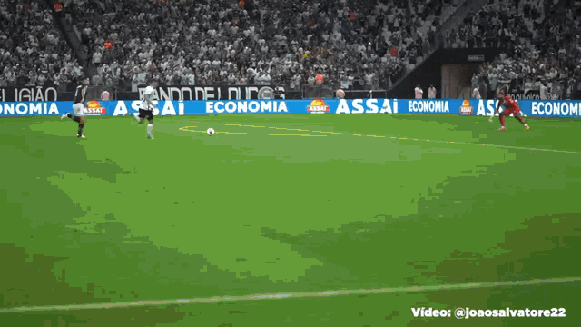 a soccer game is being played on a field with ads for assai