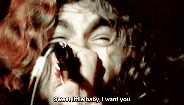 a man singing into a microphone with the words sweet little baby i want you