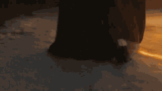 a person standing in the snow with a light coming out of the ground