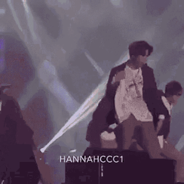 a group of people are standing on a stage .