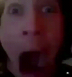 a close up of a person 's face with their tongue hanging out