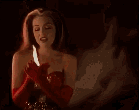 a woman with red gloves is holding a candle and the word sida is visible