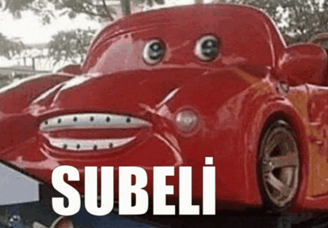 a red car with googly eyes and the word subeli written on it