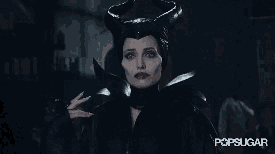 a woman in a maleficent costume is holding a knife in her hand ..