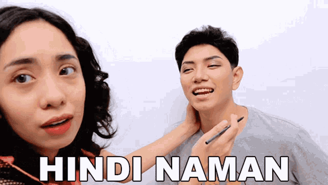 a woman is putting makeup on a man 's face and the words hindi naman are visible