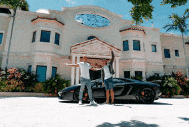 two men standing in front of a large house with a black sports car