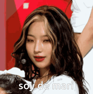 a close up of a woman 's face with the words soy de mari written on the bottom .