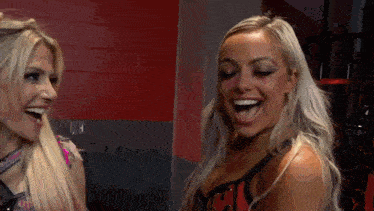 two women are laughing with their mouths open and one has blood on her face