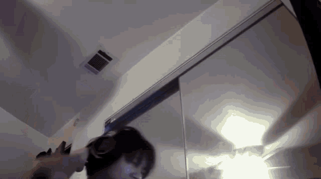 a person is standing in front of a mirror in a room