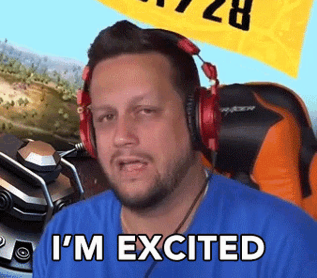a man wearing headphones says i 'm excited in front of a yellow flag