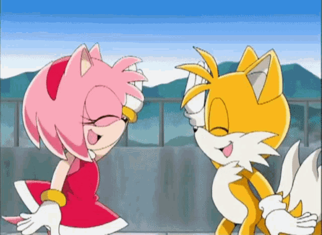 amy and tails from sonic the hedgehog are dancing together in a cartoon .