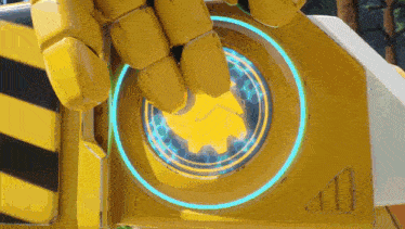 a close up of a yellow robot 's hand with a blue light surrounding it